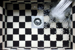 a drain on a checkered floor