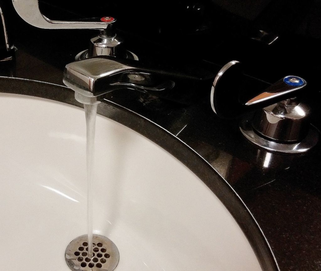  a running tap under a basin
